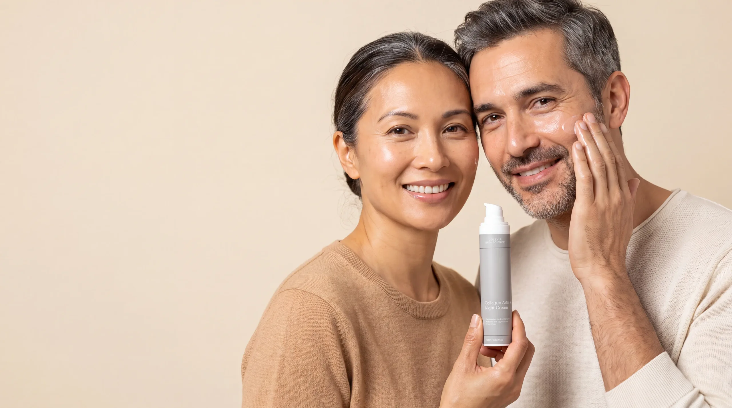 A woman and a man with greying hair smiling, the man applying cream to his cheek, the woman holding a Solevia night cream